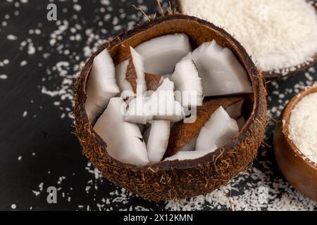 white coconut pulp and dried coconut flakes, a close-up of which is used in the preparation of desserts Stock Photo
