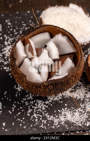 white coconut pulp and dried coconut flakes, a close-up of which is used in the preparation of desserts Stock Photo