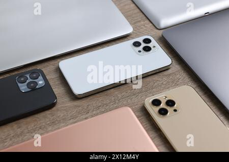 Many different modern gadgets on wooden table Stock Photo