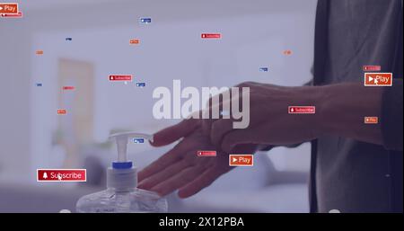 Image of media icons over caucasian woman disinfecting hands Stock Photo