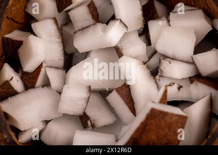 white coconut pulp and dried coconut flakes, a close-up of which is used in the preparation of desserts Stock Photo