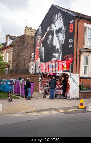 Merchandise selling beneath the Ian Rush mural outside Anfield football stadium, Liverpool Stock Photo