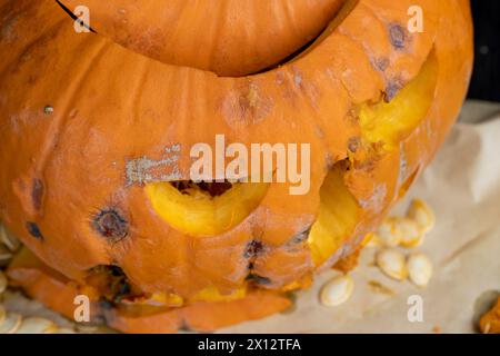 carved scary pumpkin head for Halloween, rotting orange pumpkin for Halloween Celebration Stock Photo