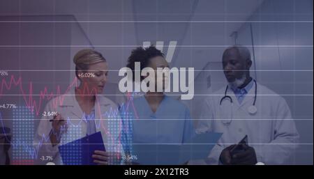 Image changing numbers, diverse doctors discussing patient reports while walking in corridor Stock Photo