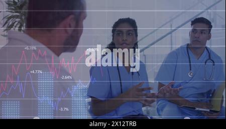 Image of multiple graphs with changing numbers over diverse doctors discussing in hospital Stock Photo