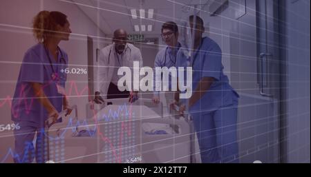 Image of graphs and changing numbers over diverse doctors rushing patient to operation room Stock Photo