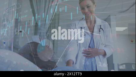 Image of graphs and trading board over diverse examining and talking with patient in hospital Stock Photo