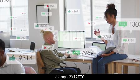 Image of multiple notification bars over diverse coworkers discussing reports on computer Stock Photo