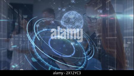 Image of lights and processing circle with globe over caucasian female doctor Stock Photo