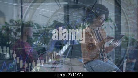 Image of clock and financial data processing over diverse business people Stock Photo