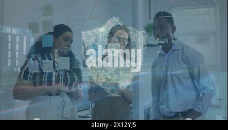 Image of cityscape with shield icon over diverse business people in office Stock Photo