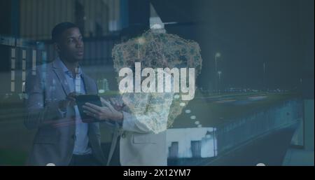 Image of cityscape with shield icon over diverse business people in office Stock Photo