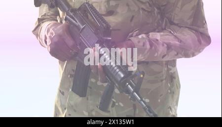 Image of portrait african american army solider holding gun and multicolored moving lens flare Stock Photo