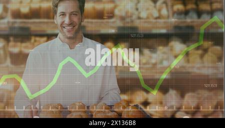 Image of financial data and graphs over happy caucasian baker Stock Photo