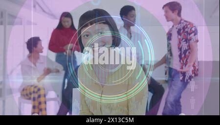 Image of neon light trails and round scanner over asian woman using digital tablet at office Stock Photo