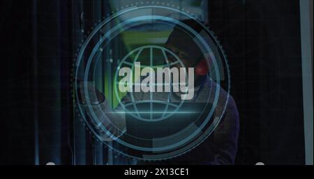 Image of web globe icon over african american male engineer using laptop at server room Stock Photo