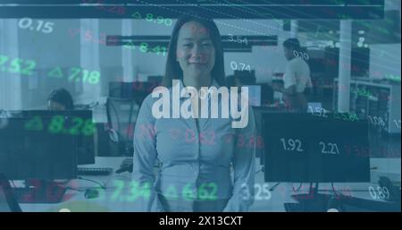 Image of cloud text in cloud and trading board over asian woman standing arms crossed in office Stock Photo