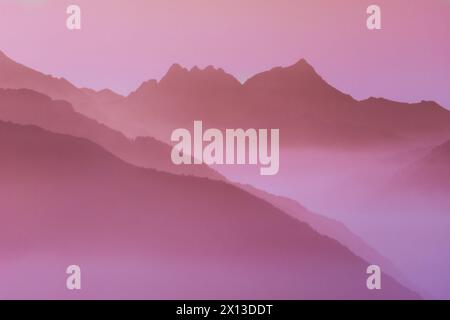 Spectacular mountain ranges silhouettes in shades of pink. Stock Photo
