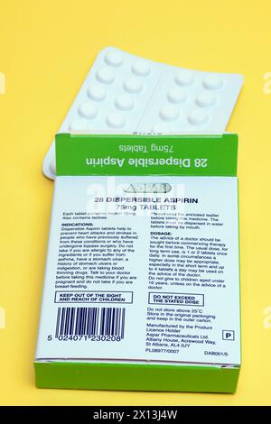 Box of 28 75mg  Dispersible  Aspirin Tablets on a Yellow Background Stock Photo