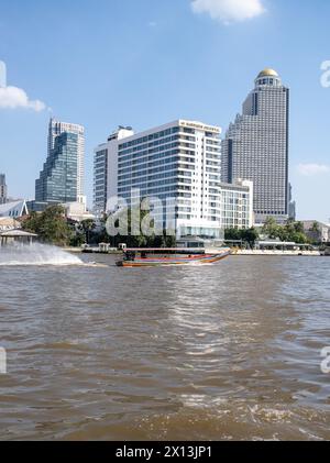 Speeding Long Boat on the Chao Phraya River in fron tof the Mandarin Oriental Hotel in Bangkok Thailand Stock Photo