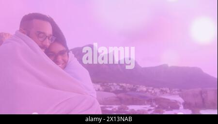 Image of glowing spots over diverse couple Stock Photo