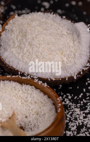 white coconut pulp and dried coconut flakes, a close-up of which is used in the preparation of desserts Stock Photo