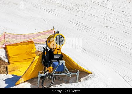 snow generator on a snow slope at a resort on a sunny day. Active recreation Stock Photo