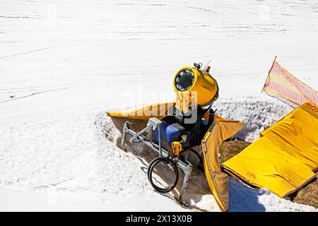 snow generator on a snow slope at a resort on a sunny day. Active recreation Stock Photo