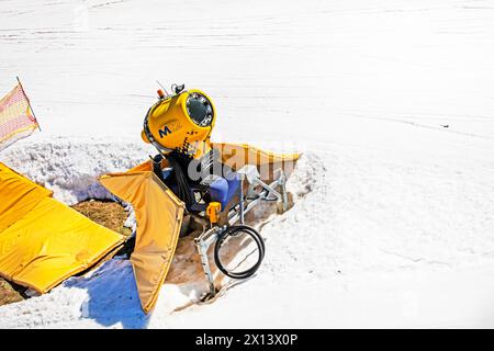 snow generator on a snow slope at a resort on a sunny day. Active recreation Stock Photo