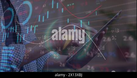 Image of statistical and stock market data processing over mid section of man using tablet Stock Photo