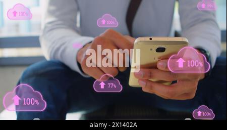 Image of digital clouds with percent going up over man using smartphone Stock Photo