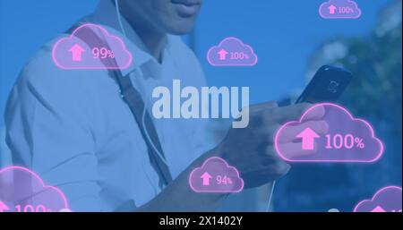 Image of digital clouds with percent going up over man using smartphone Stock Photo