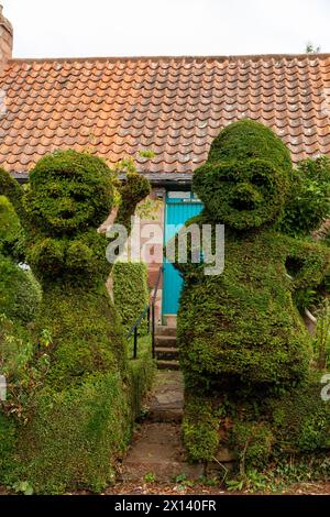 Male and female topiary figures in the village of Stenton Stock Photo