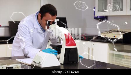 Image of scientific data processing over male scientist using microscope in laboratory Stock Photo