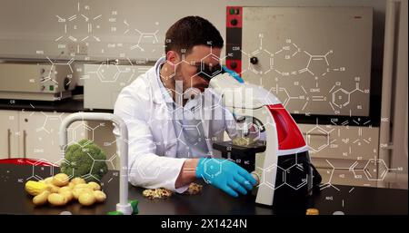 Image of chemical formulas over caucasian male lab worker using microscope Stock Photo