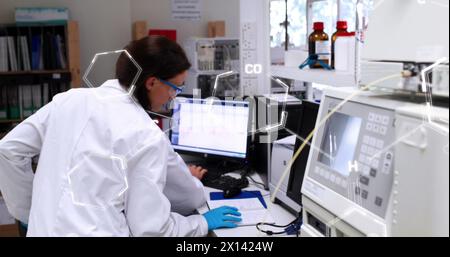 Image of chemical formulas over caucasian female lab worker using computer Stock Photo