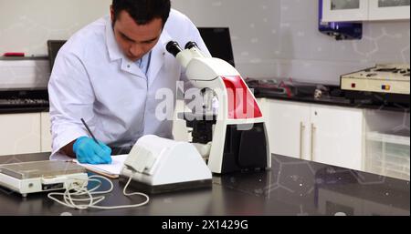 Image of chemical formulas over biracial male lab worker using microscope Stock Photo