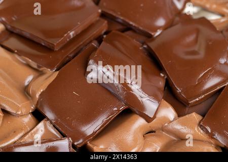 mixed together different types of chocolate, white, bitter and milk chocolate pieces Stock Photo