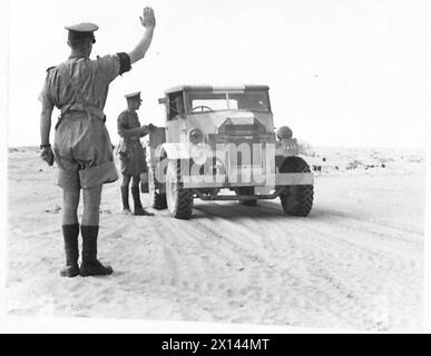 PHOTOGRAPHS TAKEN OF THE WORK OF THE MILITARY POLICE IN THE WESTERN DESERT - A road check in the desert. Cars are stopped by the Police and identity cards examined British Army Stock Photo