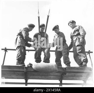 PARACHUTE TRAINING DEPOT & SCHOOL AIRBORNE FORCES - A final adjustment to his harness before he takes his turn on the trapeze British Army Stock Photo