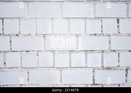 A white brick wall in daylight and cloudy weather. Stock Photo