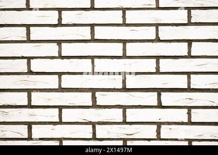 A white brick wall in daylight and cloudy weather. Stock Photo