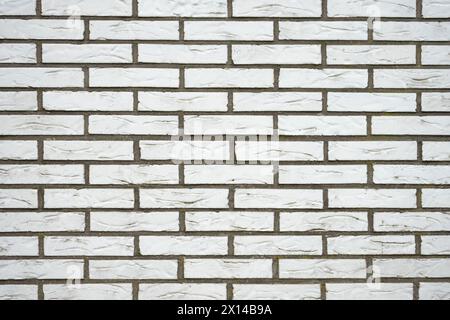 A white brick wall in daylight and cloudy weather. Stock Photo