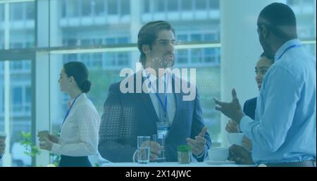 Image of binary coding data processing over diverse businesspeople discussing at office Stock Photo