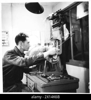 THE ACTIVITIES OF THE ROYAL ELECTRICAL AND MECHANICAL ENGINEERS - Operating a fuel pump tester is Craftsman F. McGrane of Twickenham, London. He was a compositor and is now a Diesel Engine Expert British Army Stock Photo