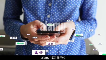 Image of social media text and icons over caucasian man with smartphone at home Stock Photo