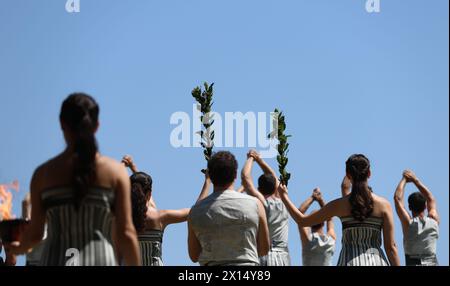 Ancient Olympia, Greece. 15th Apr, 2024. Actresses playing the role of ancient priestesses hold the olive branches during the final dress rehearsal of the Olympic flame lighting ceremony for the Paris 2024 Summer Olympic Games in Ancient Olympia, Greece, on April 15, 2024. Credit: Li Jing/Xinhua/Alamy Live News Stock Photo