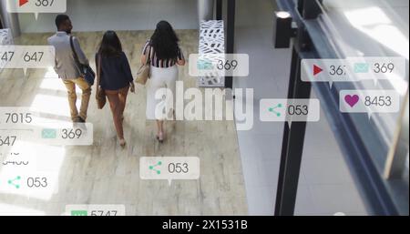Image of notification bars over diverse coworkers discussing while walking out of office Stock Photo