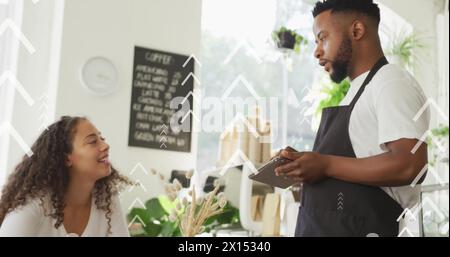 Image of up arrows over diverse male barista noting down order given by woman in cafes Stock Photo
