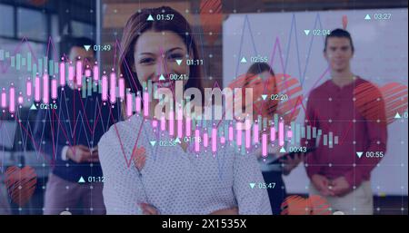 Image of changing numbers, graphs and heart icons over diverse coworkers standing in office Stock Photo
